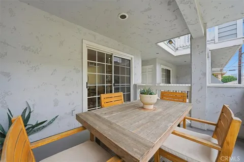 a room with furniture pool table and glass door