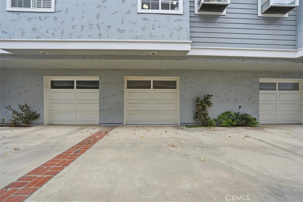 1534 Marcelina Avenue, Unit D Torrance, CA 90501 - Photo 24 of 29 a front view of a house with a yard and garage