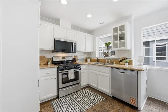 a kitchen with stainless steel appliances granite countertop a stove and a sink