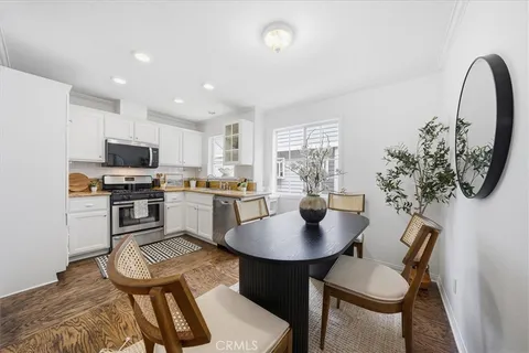 a kitchen with a table chairs and a dining table