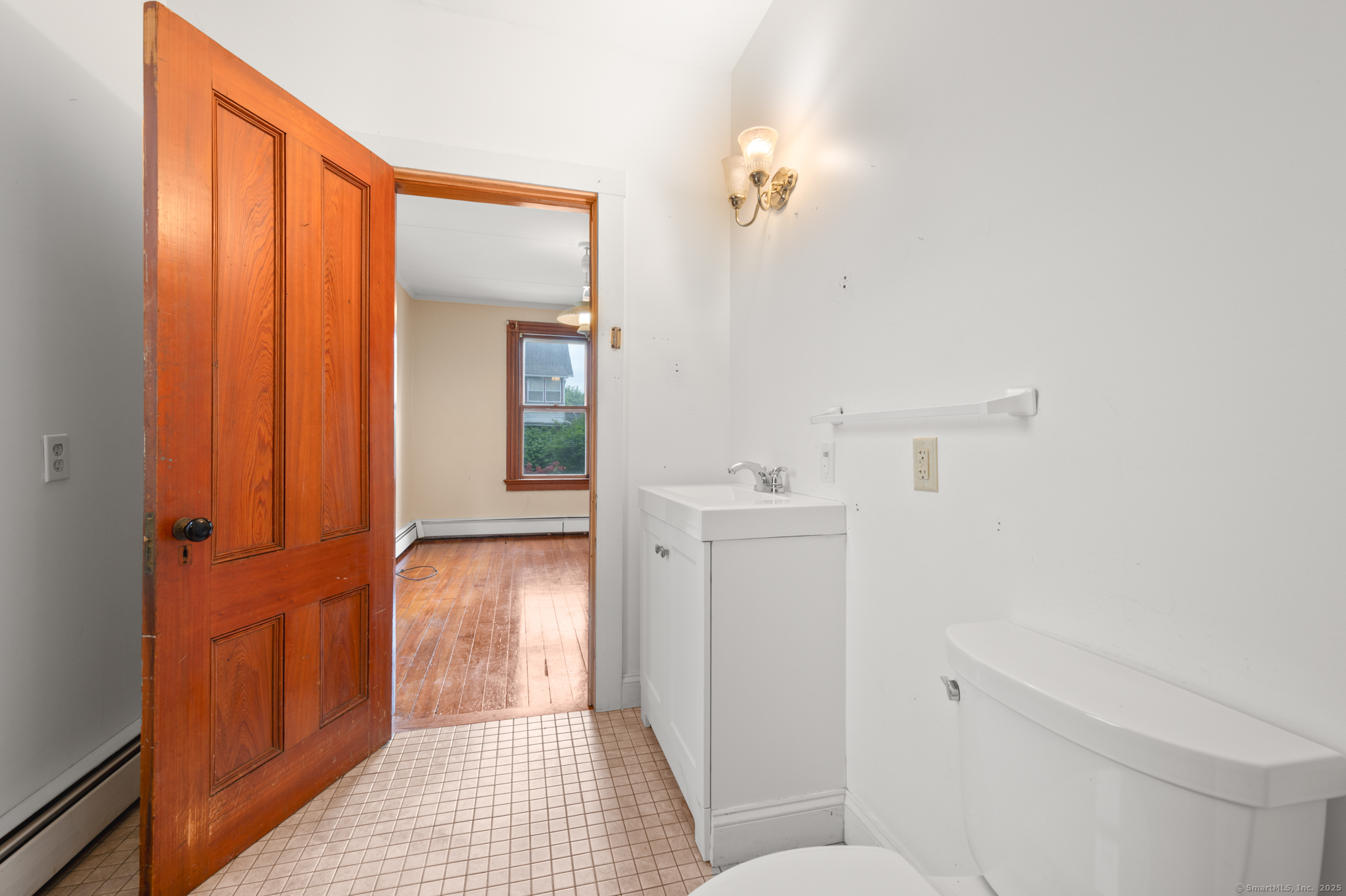 175 Lincoln Street Middletown, CT 06457 - Photo 17 of 33 a bathroom with a sink and mirror with toilet