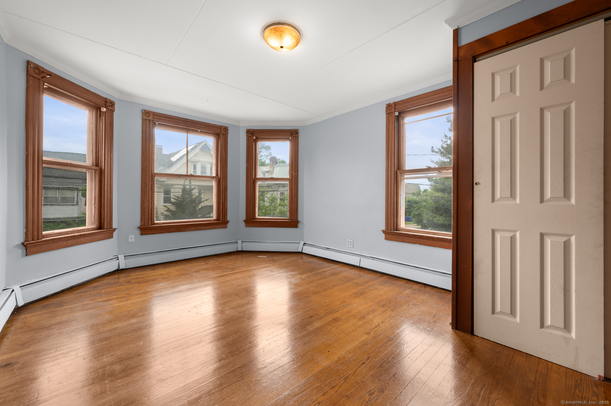 175 Lincoln Street Middletown, CT 06457 - Photo 20 of 33 a view of an empty room with wooden floor and a window