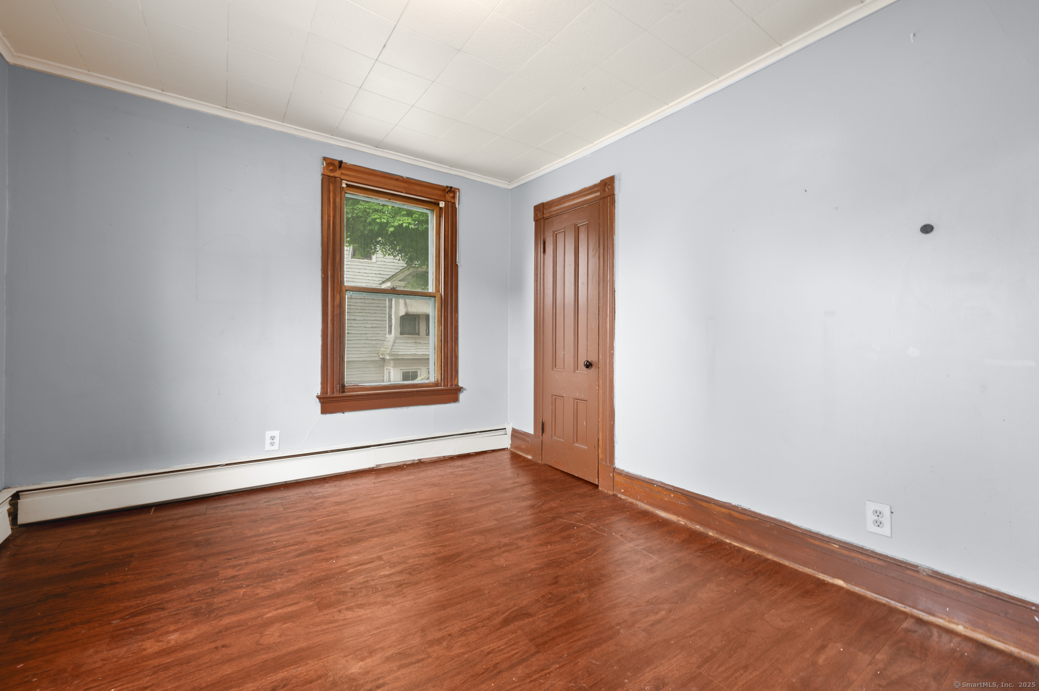 175 Lincoln Street Middletown, CT 06457 - Photo 23 of 33 a view of an empty room with window and wooden floor