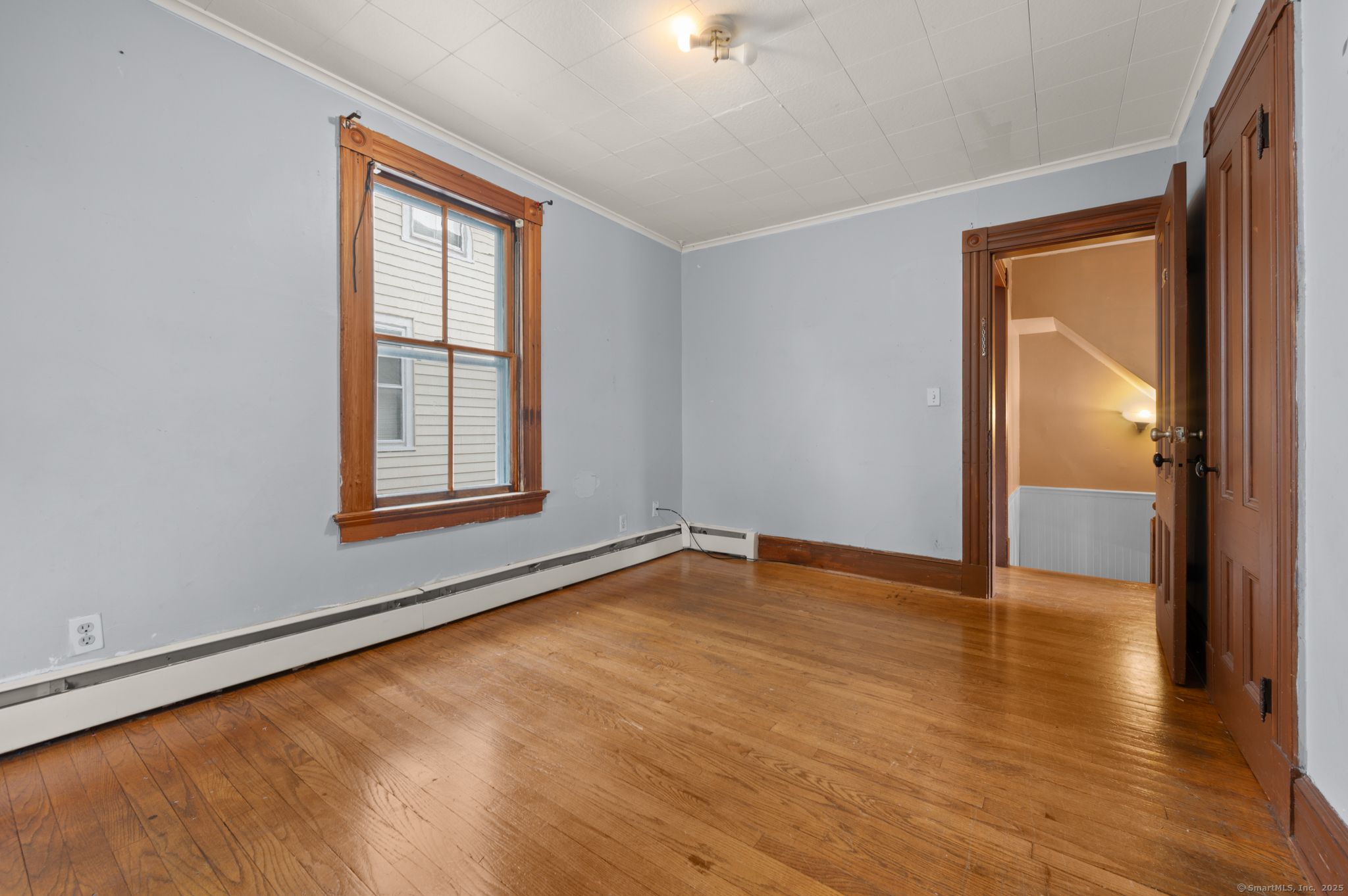 175 Lincoln Street Middletown, CT 06457 - Photo 26 of 33 an empty room with wooden floor and windows