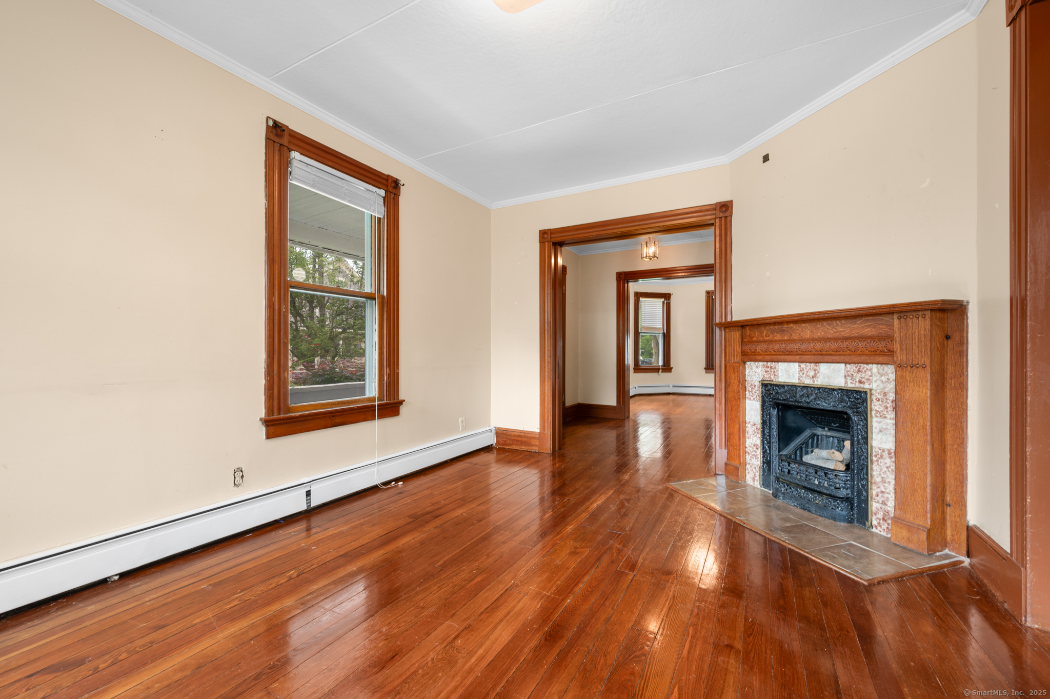 175 Lincoln Street Middletown, CT 06457 - Photo 9 of 33 a view of an empty room with wooden floor fireplace and a window
