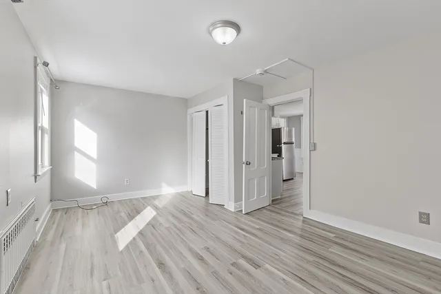 wooden floor in an empty room with a window