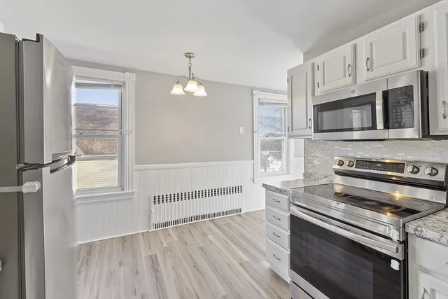a kitchen with stainless steel appliances a stove microwave and cabinets