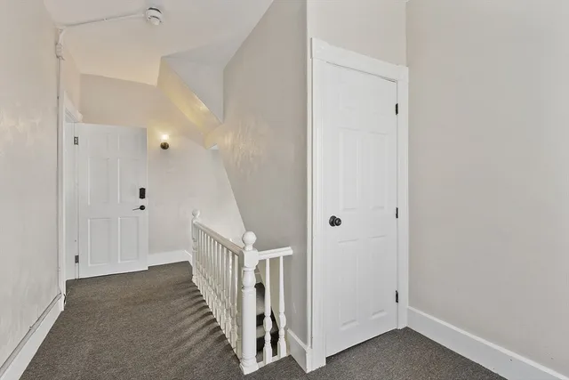 a view of a hallway with white walls