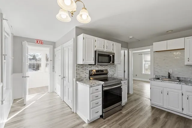 a kitchen with stainless steel appliances granite countertop a stove and a sink