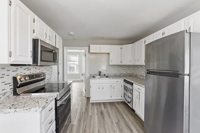 a kitchen with a refrigerator stove and sink