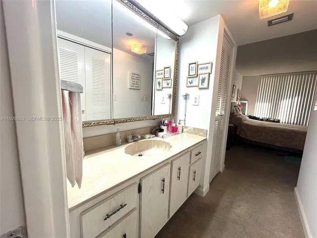 a bathroom with a double vanity sink and a mirror