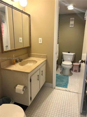 a bathroom with a sink a toilet and mirror