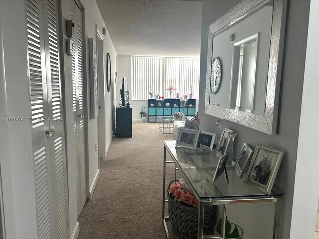 a view of a hallway with furniture and front door