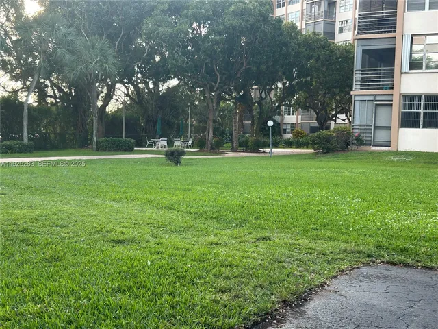 a front view of a house with a garden and sitting area