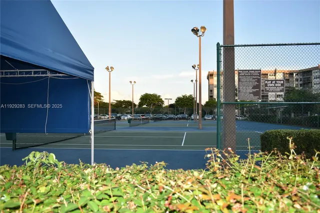 a view of a patio with a table and chairs under an umbrella