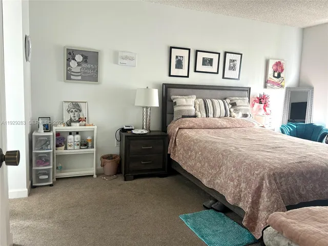 a bedroom with a bed and a view of bedroom