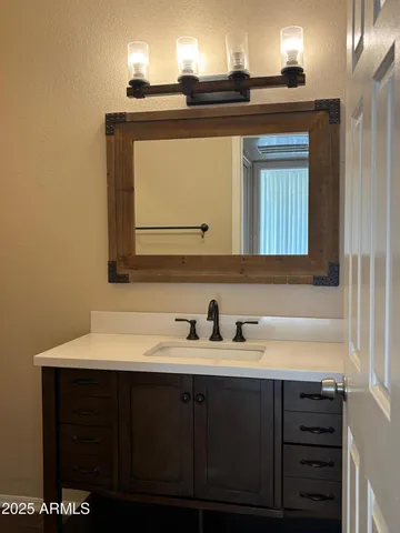 a bathroom with a sink and a mirror