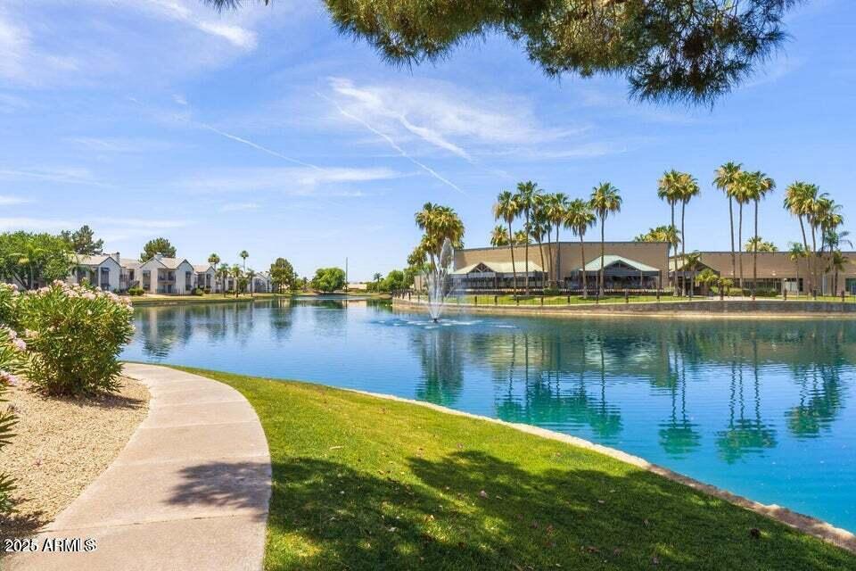 1825 West Ray Road, Unit 2082 Chandler, AZ 85224 - Photo 28 of 37 a view of a lake with houses in the back