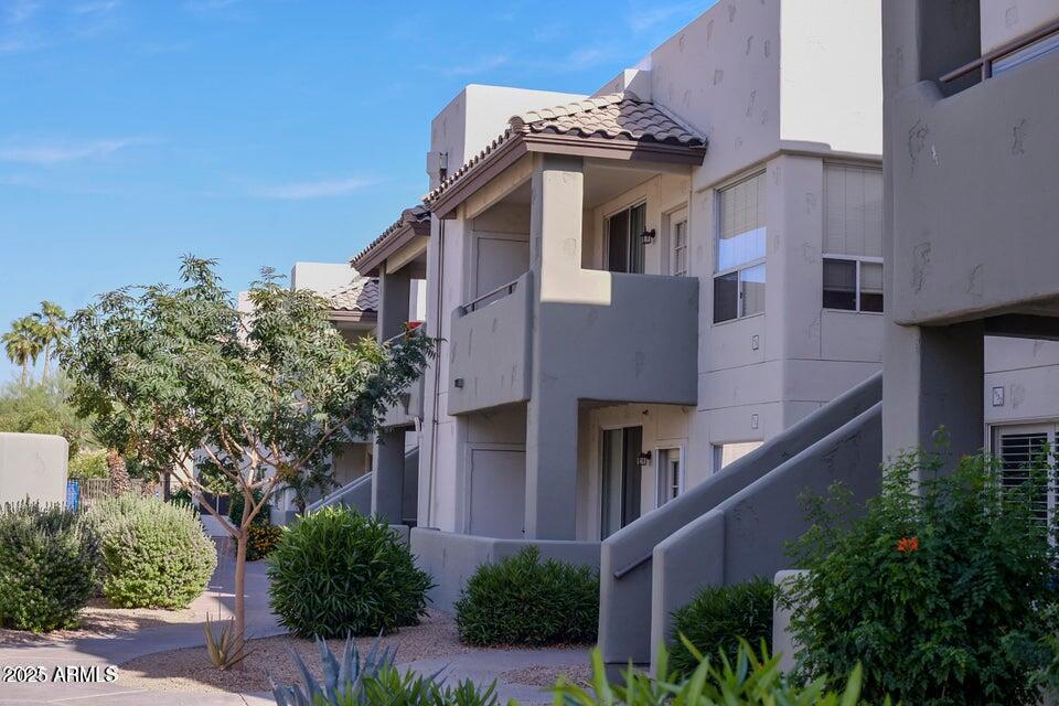 1825 West Ray Road, Unit 2082 Chandler, AZ 85224 - Photo 3 of 37 a yellow building with trees in front of it