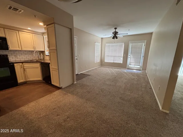 a view of a kitchen with refrigerator and microwave