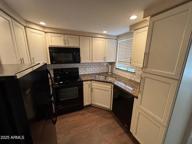 a kitchen with a refrigerator stove and microwave