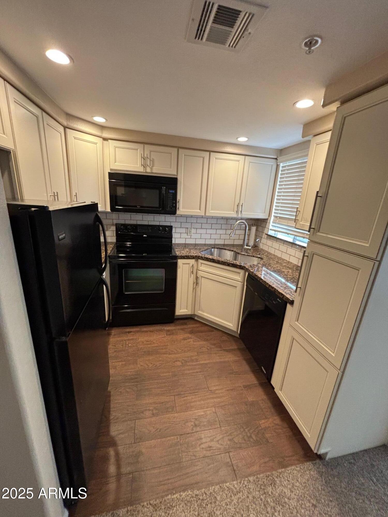 1825 West Ray Road, Unit 2082 Chandler, AZ 85224 - Photo 9 of 37 a view of kitchen with refrigerator stove and cabinets