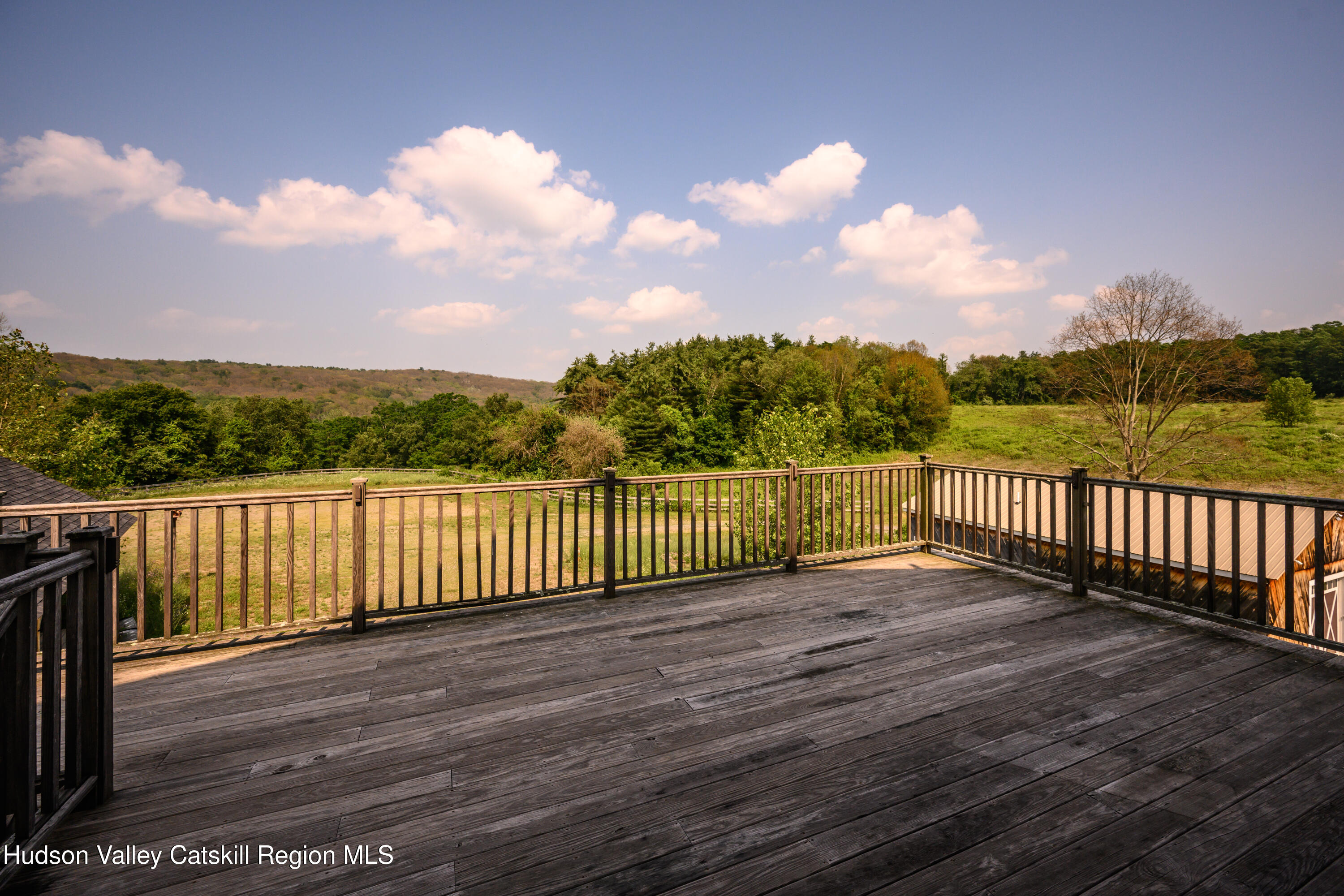 70-98 Ryan Road Pine Plains, NY 12567 - Photo 16 of 22 a view of a balcony with wooden fence