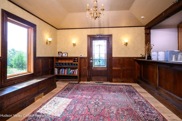 a view of a hallway with furniture and window
