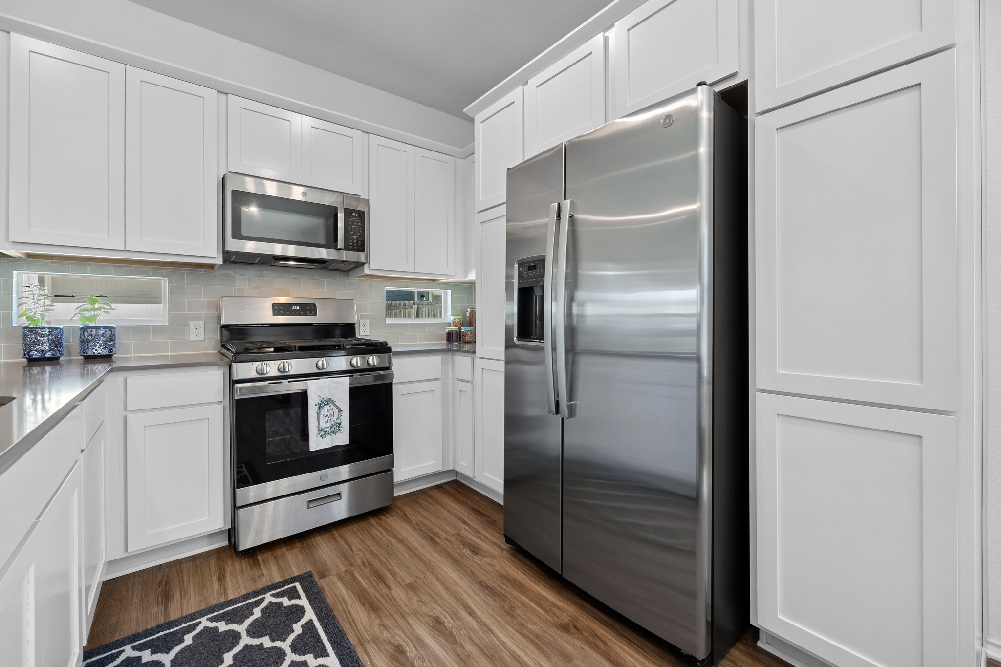 1500 Linwood Street Leander, TX 78641 - Photo 12 of 38 a kitchen with stainless steel appliances a refrigerator stove and microwave