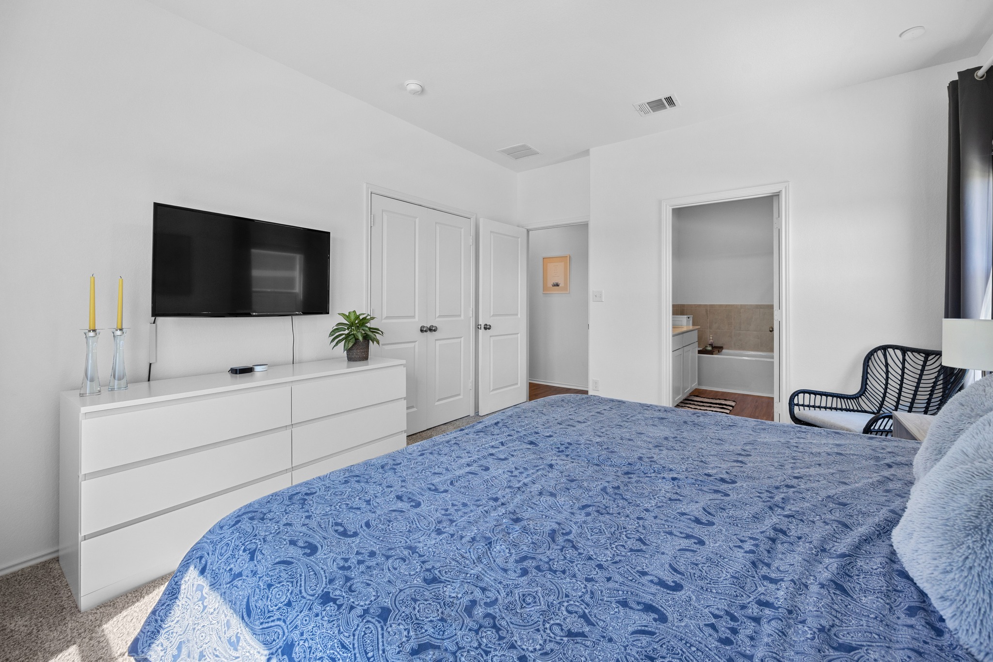 1500 Linwood Street Leander, TX 78641 - Photo 16 of 38 a spacious bedroom with a bed and a flat screen tv