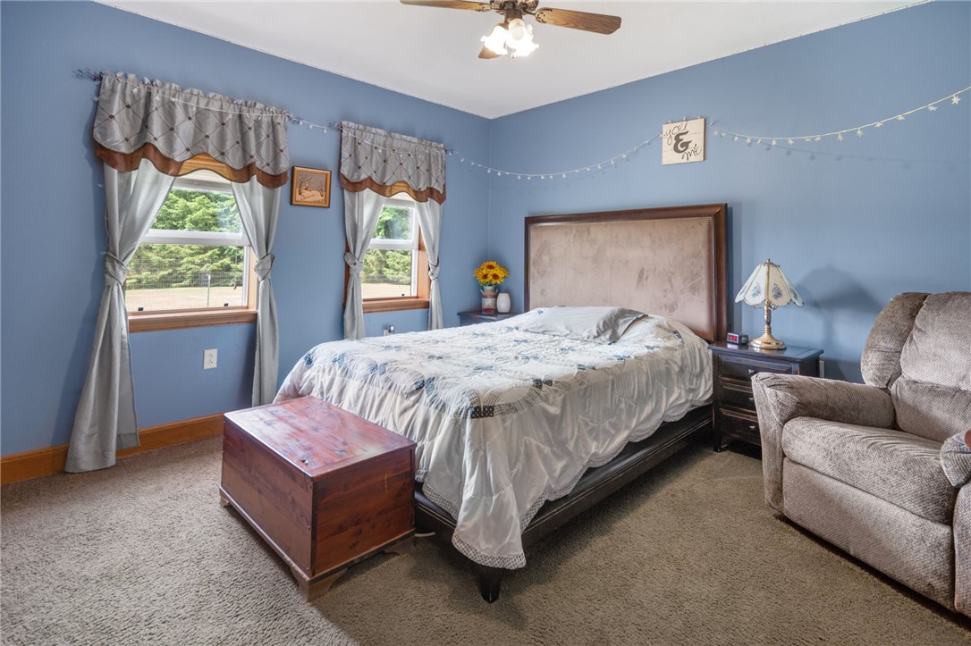 5903 Howell Road Locke, NY 13092 - Photo 15 of 44 First floor primary bedroom overlooking your beautiful private pond