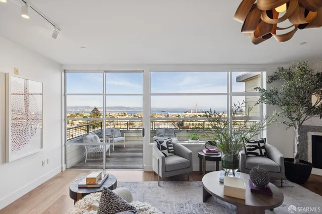 a living room with patio furniture and a floor to ceiling window