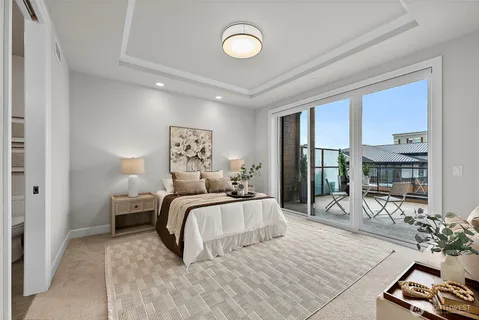 a bedroom with bed and a large window