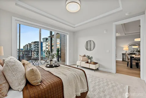 a bedroom with a bed a large window and a couch