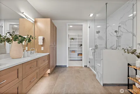 a bathroom with a double vanity sink and a mirror