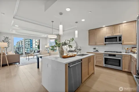a kitchen with stainless steel appliances granite countertop a sink and a stove