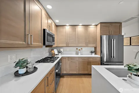 a kitchen with a sink stove and chairs