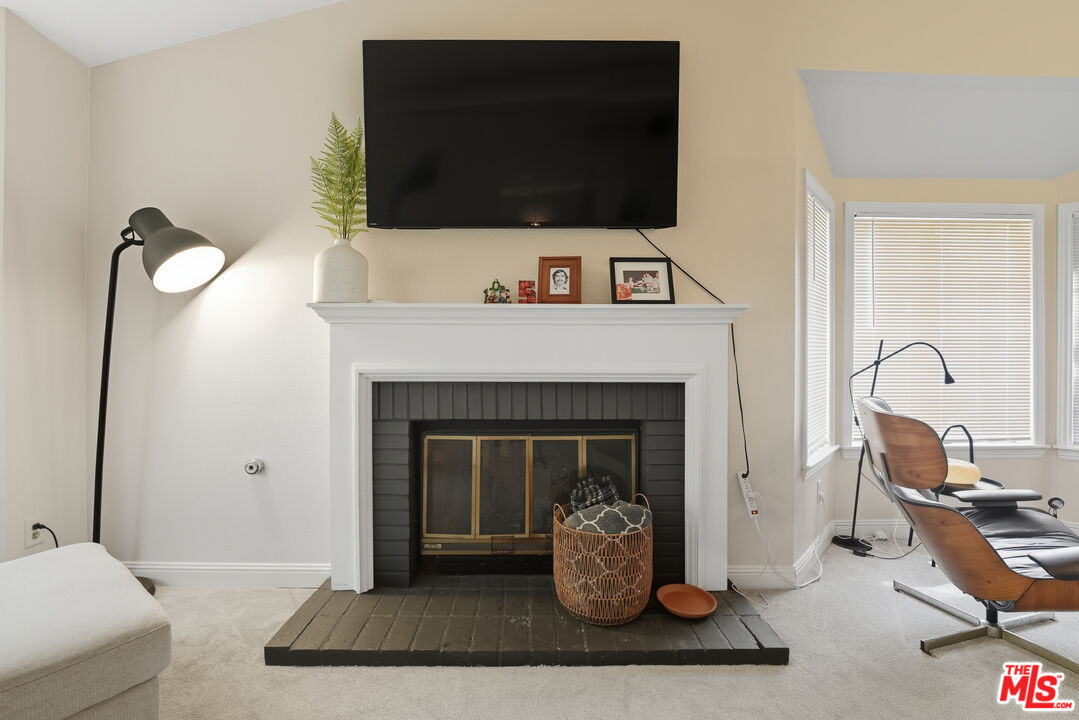 2048 East Ave R 10 Palmdale, CA 93550 - Photo 13 of 45 a living room with furniture and a fireplace