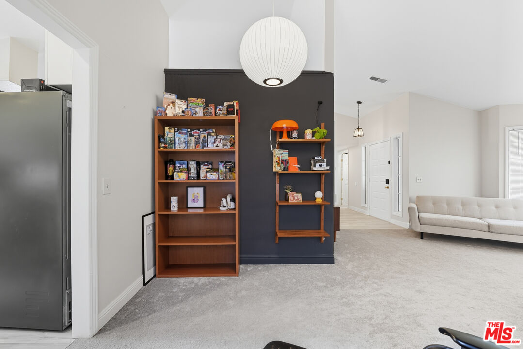 2048 East Ave R 10 Palmdale, CA 93550 - Photo 14 of 45 a living room with furniture cabinets and a book shelf