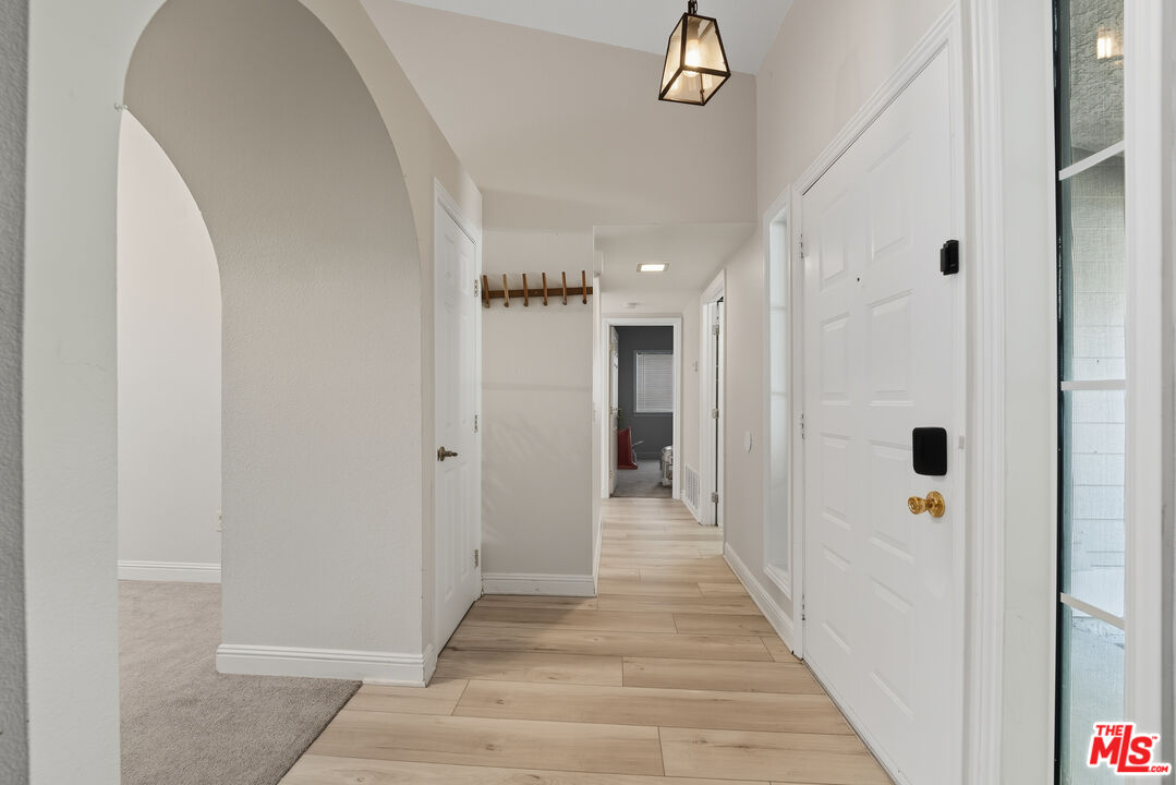 2048 East Ave R 10 Palmdale, CA 93550 - Photo 25 of 45 a view of a hallway with a wooden space