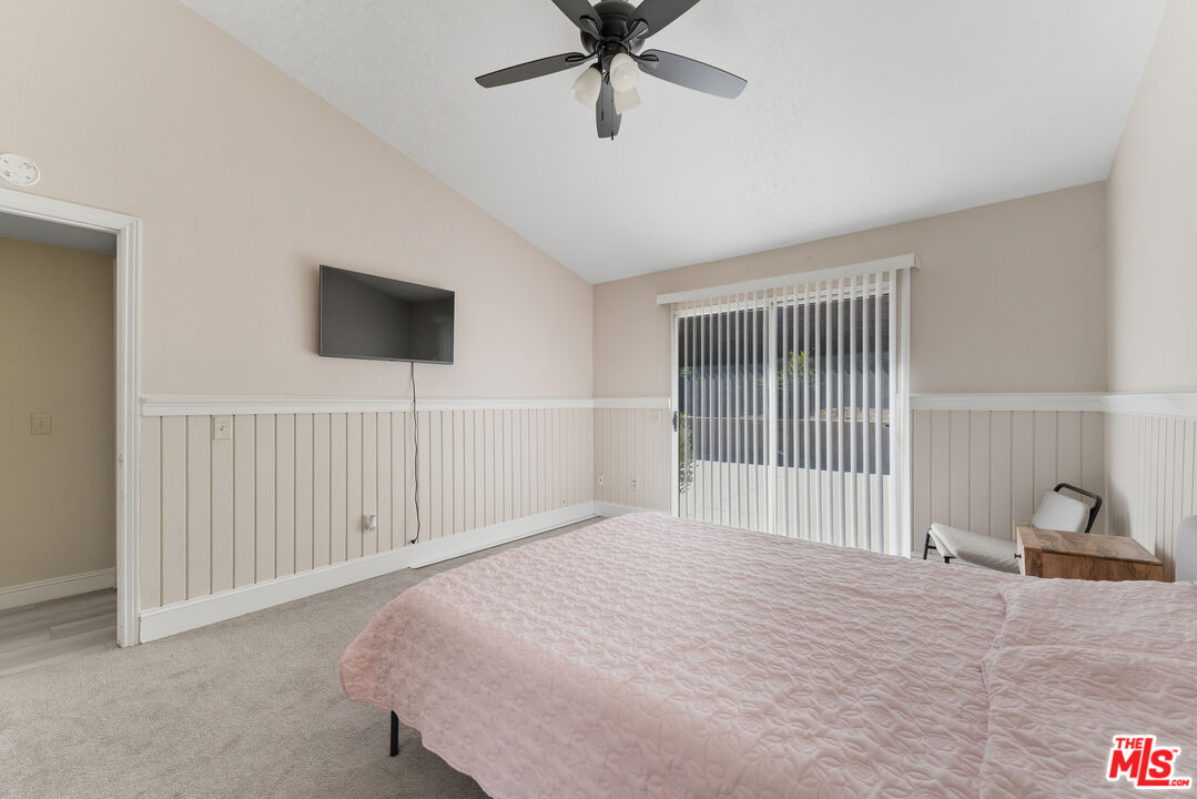 2048 East Ave R 10 Palmdale, CA 93550 - Photo 29 of 45 a bedroom with a bed and a window