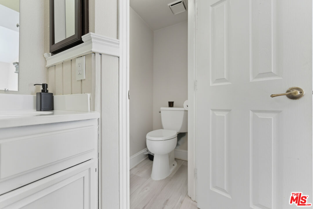 2048 East Ave R 10 Palmdale, CA 93550 - Photo 30 of 45 a bathroom with a toilet sink and mirror