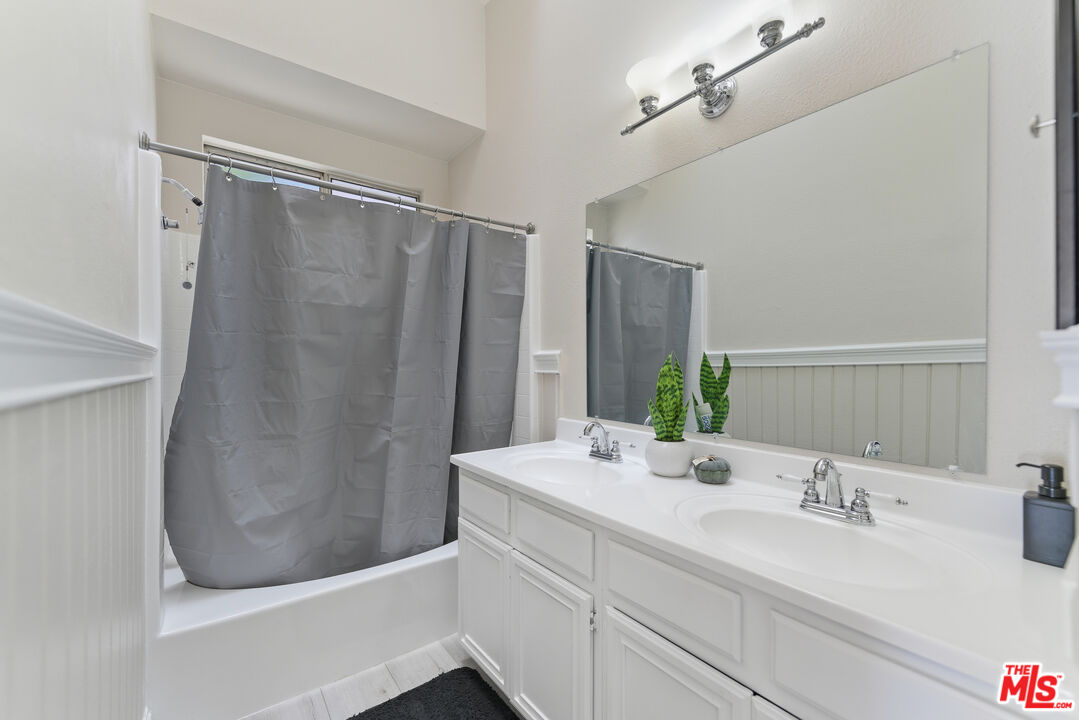 2048 East Ave R 10 Palmdale, CA 93550 - Photo 32 of 45 a bathroom with a double vanity sink and a mirror