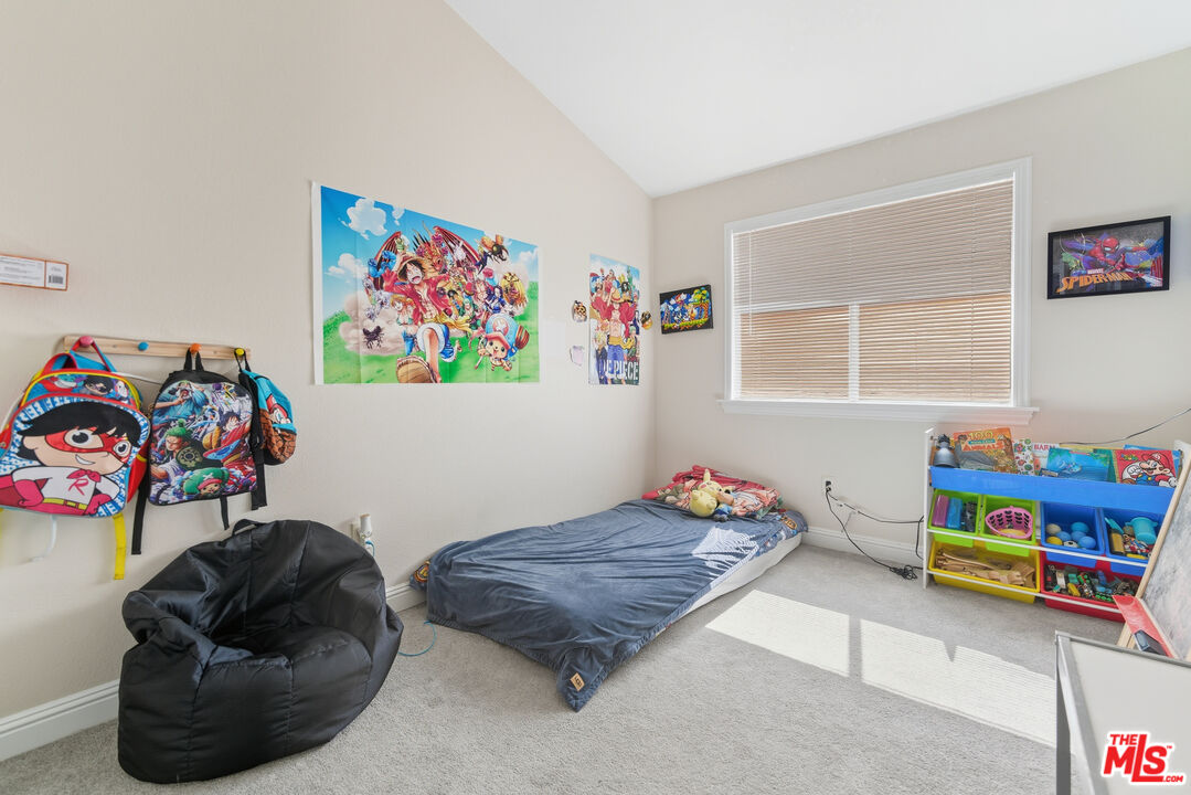 2048 East Ave R 10 Palmdale, CA 93550 - Photo 33 of 45 a bedroom with a bed and a couch