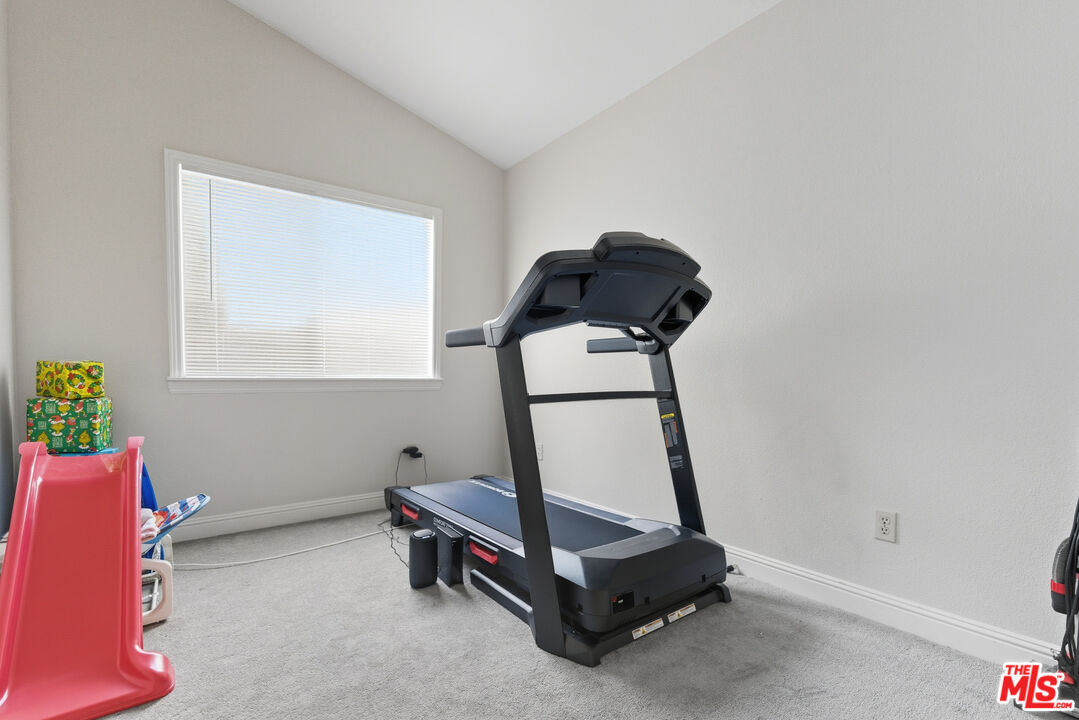 2048 East Ave R 10 Palmdale, CA 93550 - Photo 34 of 45 a bedroom with a bed and a window