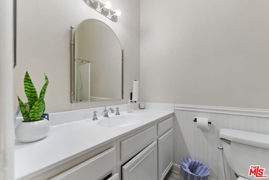 2048 East Ave R 10 Palmdale, CA 93550 - Photo 37 of 45 a bathroom with a sink a mirror and a potted plant