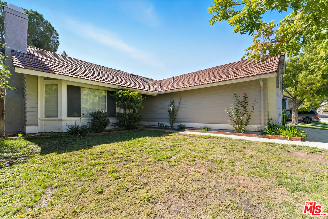 2048 East Ave R 10 Palmdale, CA 93550 - Photo 6 of 45 a front view of a house with garden