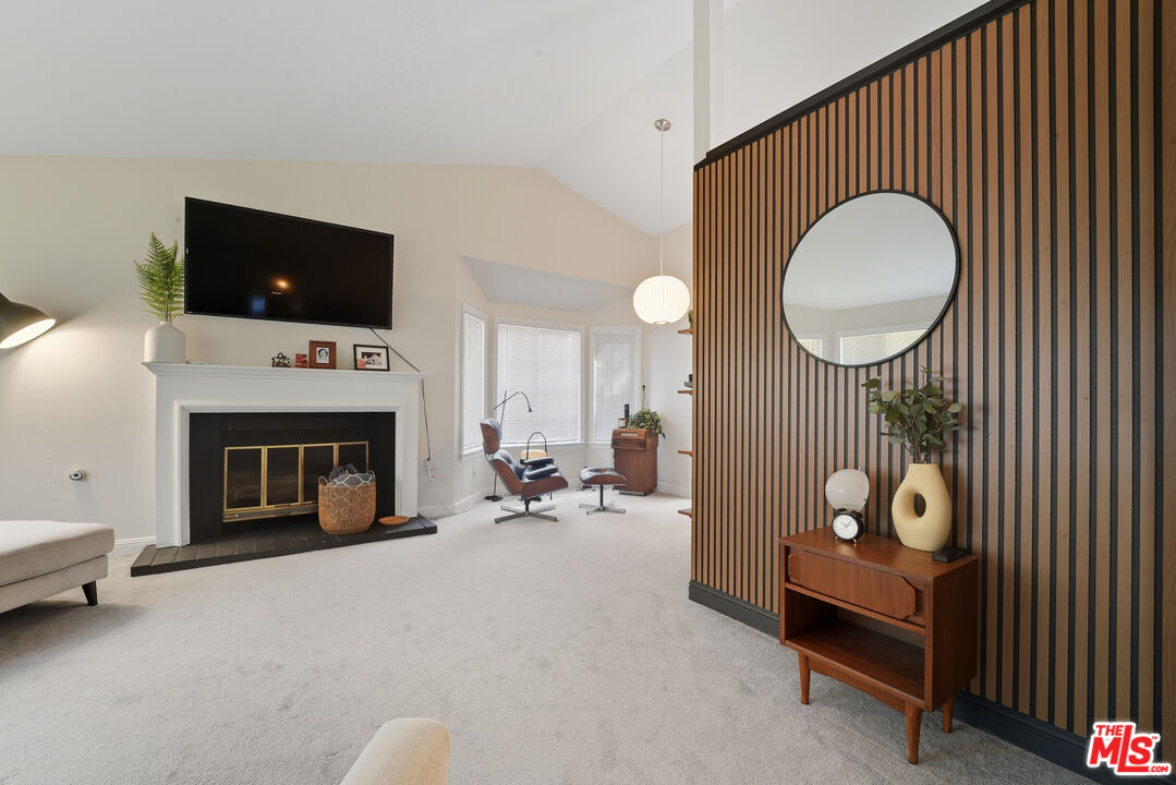 2048 East Ave R 10 Palmdale, CA 93550 - Photo 9 of 45 a living room with furniture a flat screen tv and a fireplace