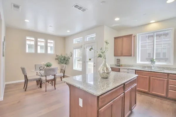a kitchen with center island table and chairs in it