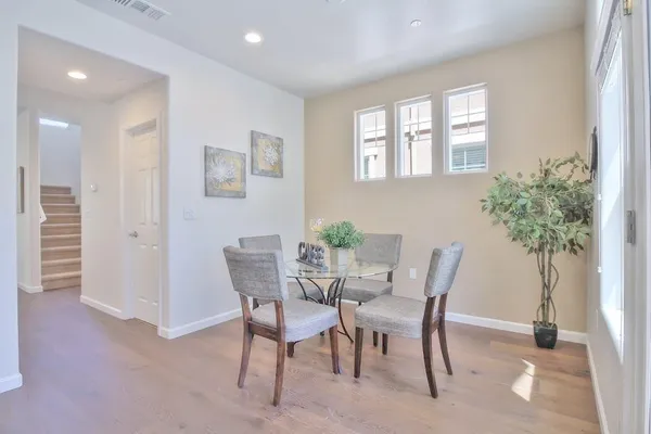 a view of a dining room with furniture and a potted plant